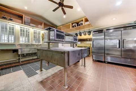 a kitchen with stainless steel appliances granite countertop a sink a stove and a refrigerator