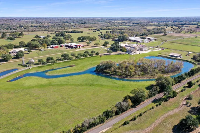 an aerial view of a residential houses with outdoor space and swimming pool
