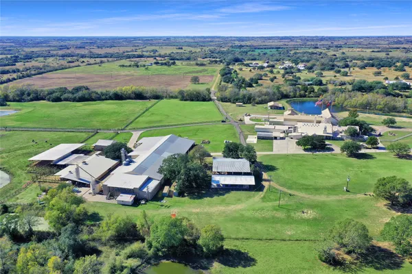 an aerial view of a house with outdoor space