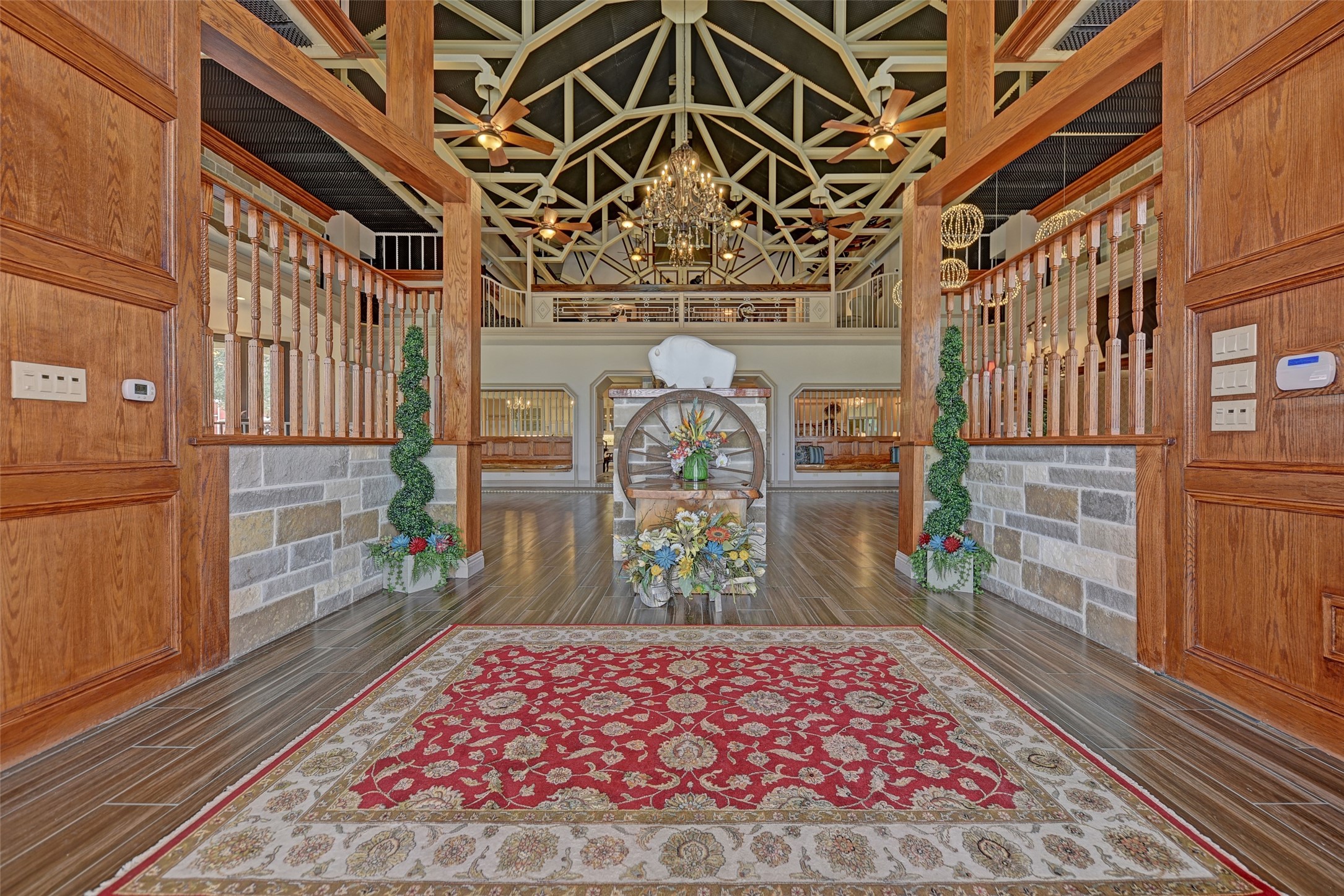 9950 Palestine Road Brenham, TX 77833 - Photo 8 of 49 The expansive 4,000+ SF great room was designed to entertain! This stunning space is complete with a bar area, multiple seating areas, a spacious formal dining room with an adjacent 26' caterer's kitchen, surround sound, custom lighting, and is lined with seamless energy-efficient windows with panoramic land views.