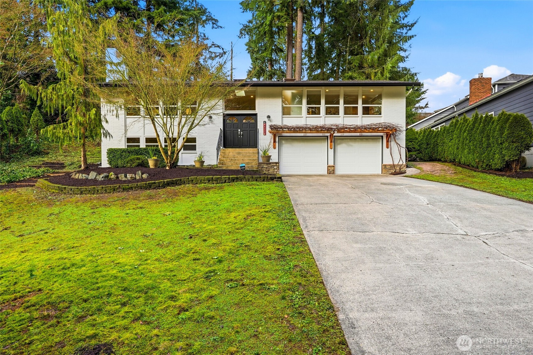 a view of a house with a yard and a garage