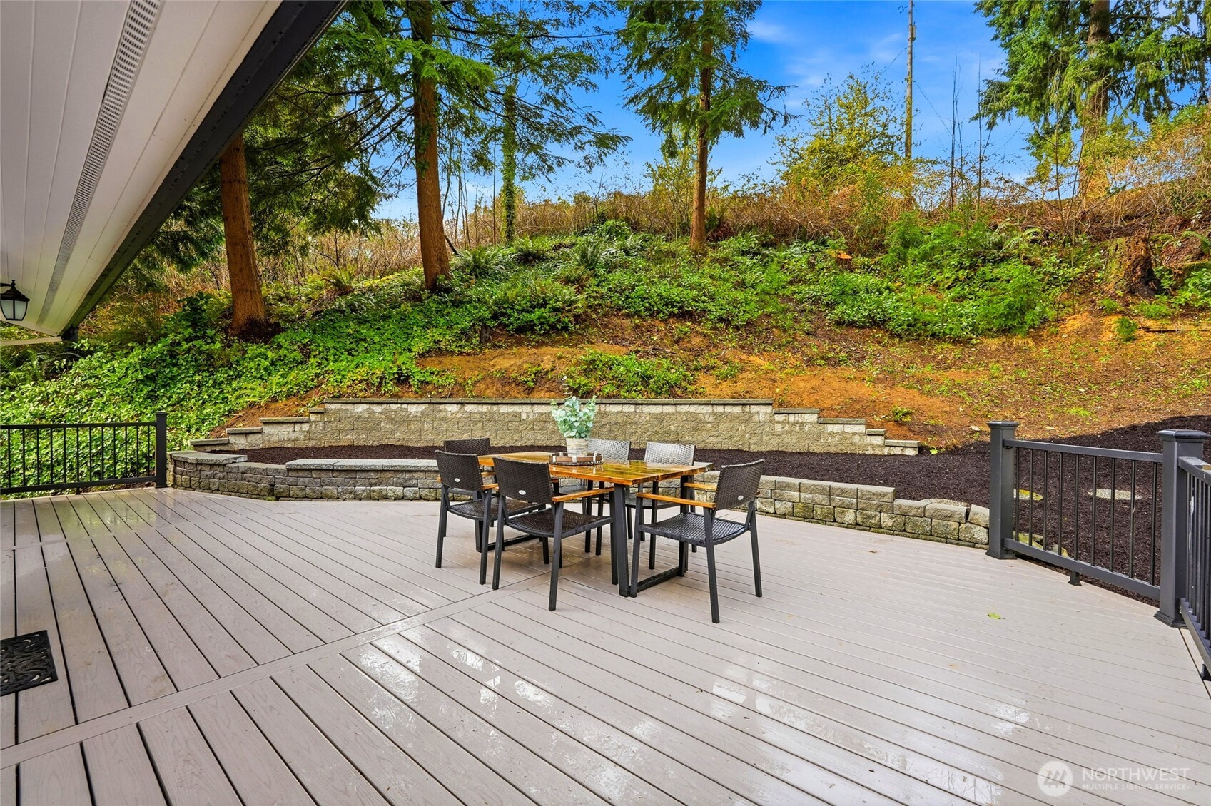 4822 Fowler Avenue Everett, WA 98203 - Photo 4 of 40 a view of a roof deck with table and chairs floor to ceiling window with wooden floor