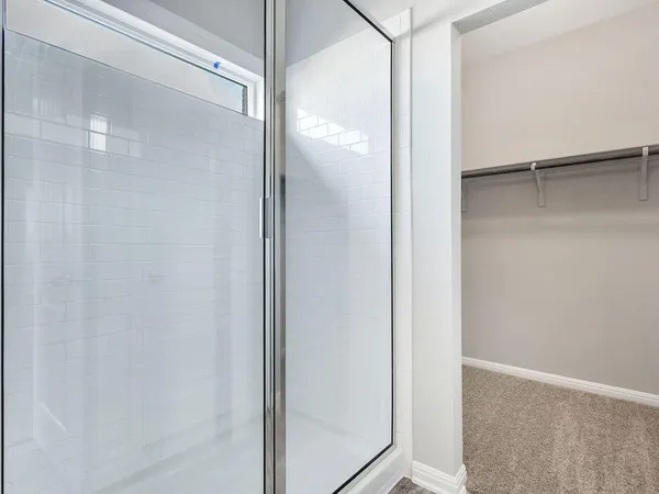 a bathroom with a glass shower door