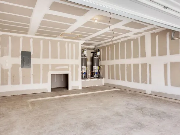 a view of an empty room with fireplace and a window
