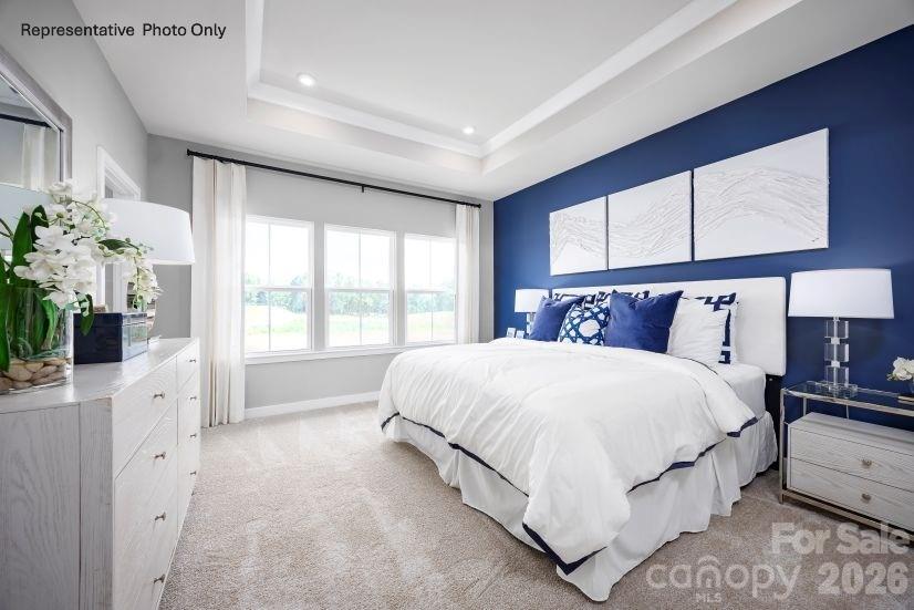 2283 Flicker Road, Unit 1050C Indian Land, SC 29707 - Photo 6 of 17 a bedroom with a large bed and a window