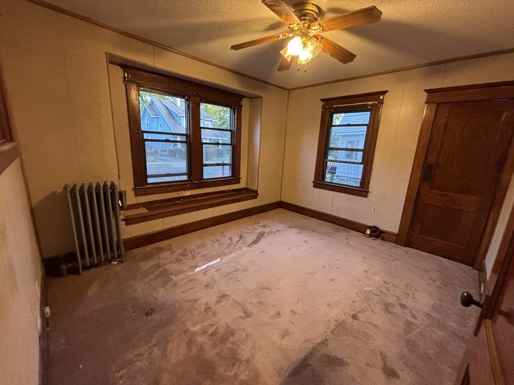 88 Dunmoreland Street Springfield, MA 01109 - Photo 16 of 29 wooden floor and window in an empty room