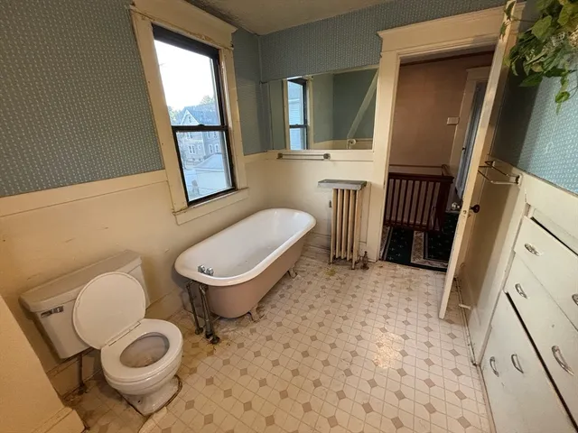 a bathroom with a tub and a window