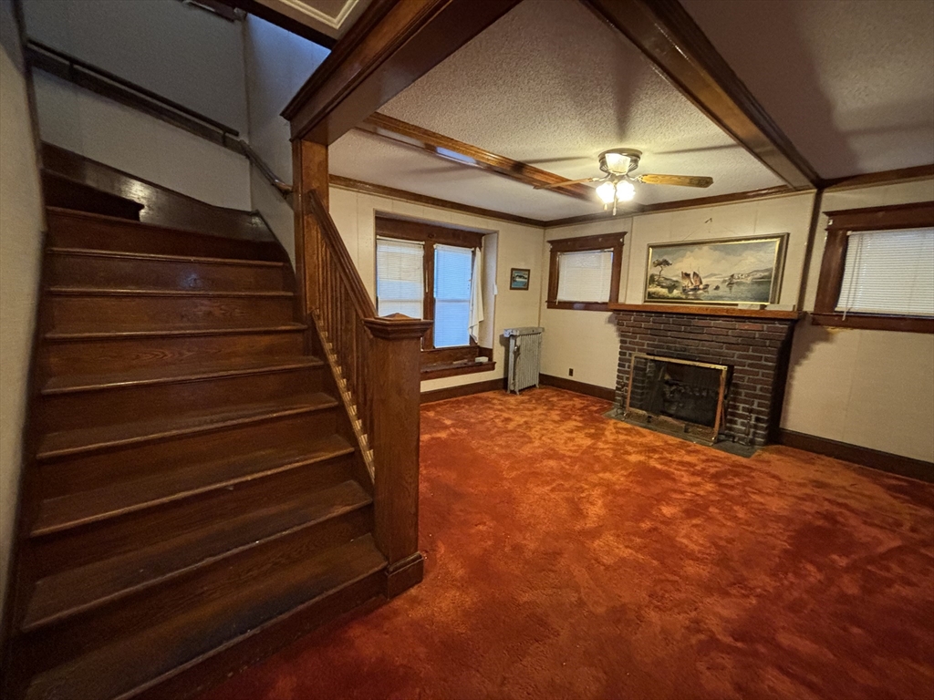 88 Dunmoreland Street Springfield, MA 01109 - Photo 7 of 29 a view of an empty room with stairs and a stove