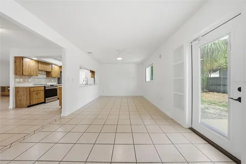 a view of a livingroom with kitchen and furniture