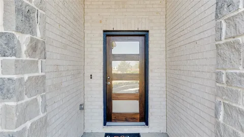a view of an empty room with a window and cabinet