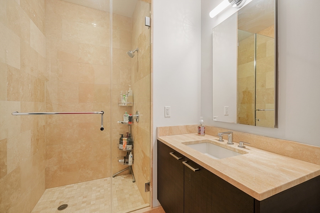 1 Franklin Street, Unit 4802 Boston, MA 02110 - Photo 26 of 42 a bathroom with a sink and a mirror