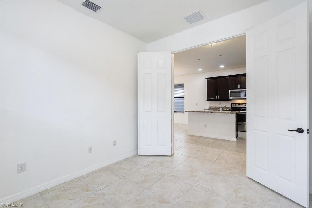 5423 Useppa Drive Ave Maria, FL 34142 - Photo 11 of 35 a view of kitchen with wooden floor and electronic appliances