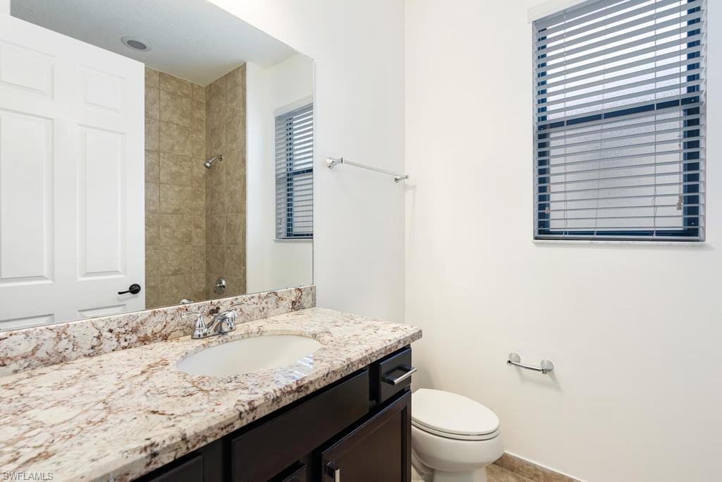 5423 Useppa Drive Ave Maria, FL 34142 - Photo 12 of 35 a bathroom with a granite countertop sink toilet and a mirror