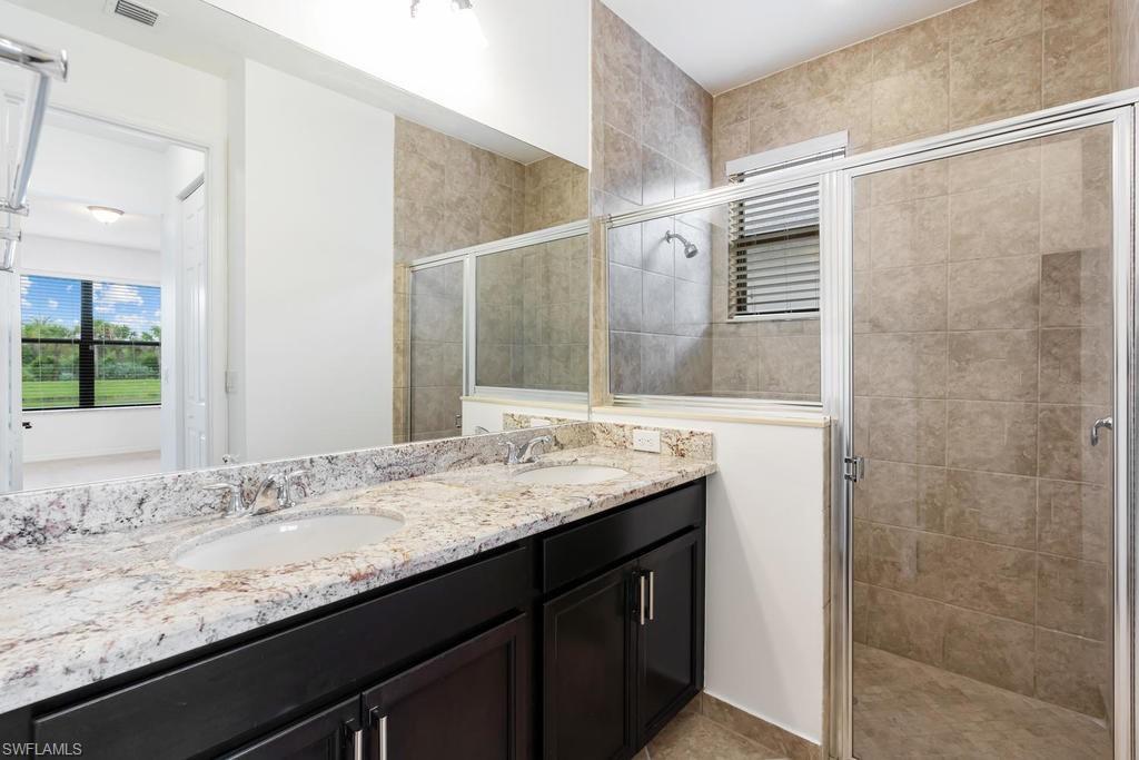 5423 Useppa Drive Ave Maria, FL 34142 - Photo 19 of 35 a bathroom with a granite countertop sink and a mirror