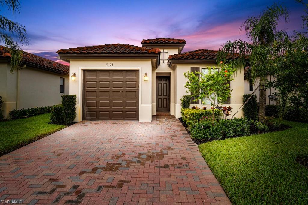 5423 Useppa Drive Ave Maria, FL 34142 - Photo 2 of 35 a front view of a house with a yard