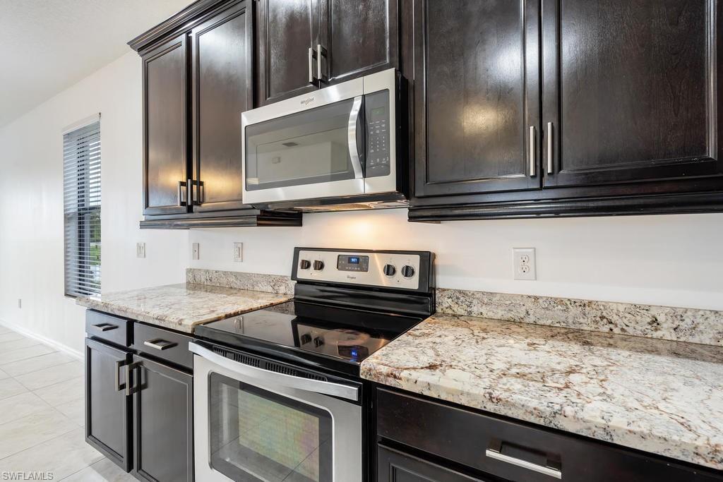 5423 Useppa Drive Ave Maria, FL 34142 - Photo 5 of 35 a view of a kitchen counter top space and stainless steel appliances