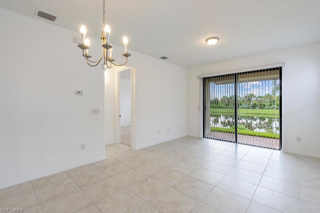 5423 Useppa Drive Ave Maria, FL 34142 - Photo 8 of 35 a view of a livingroom with a chandelier fan