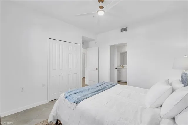a bathroom with a granite countertop sink a toilet and mirror