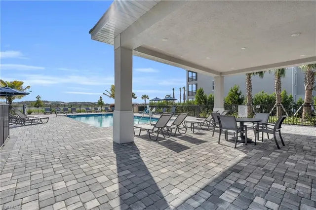 a view of swimming pool with outdoor seating and plants