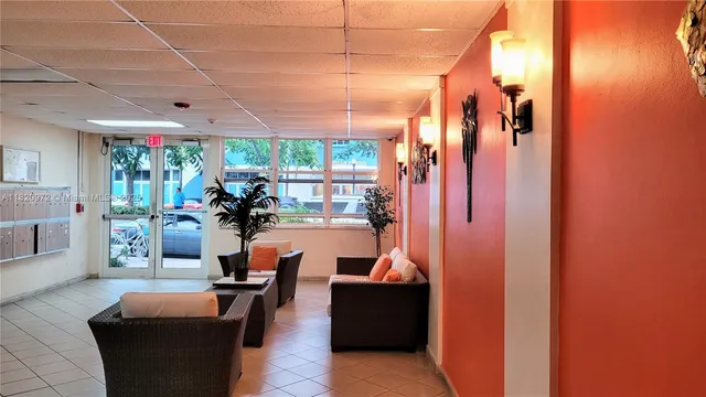 a living room with patio furniture and a large window
