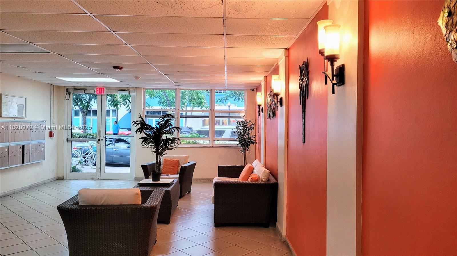 a living room with patio furniture and a large window