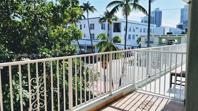 a view of a balcony with potted plants