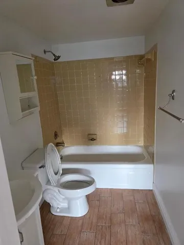 a view of kitchen and a hallway with wooden floor