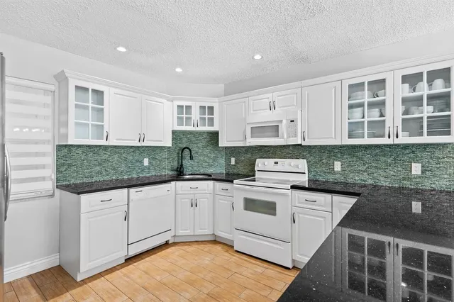 a white toilet sitting next to a bathroom sink