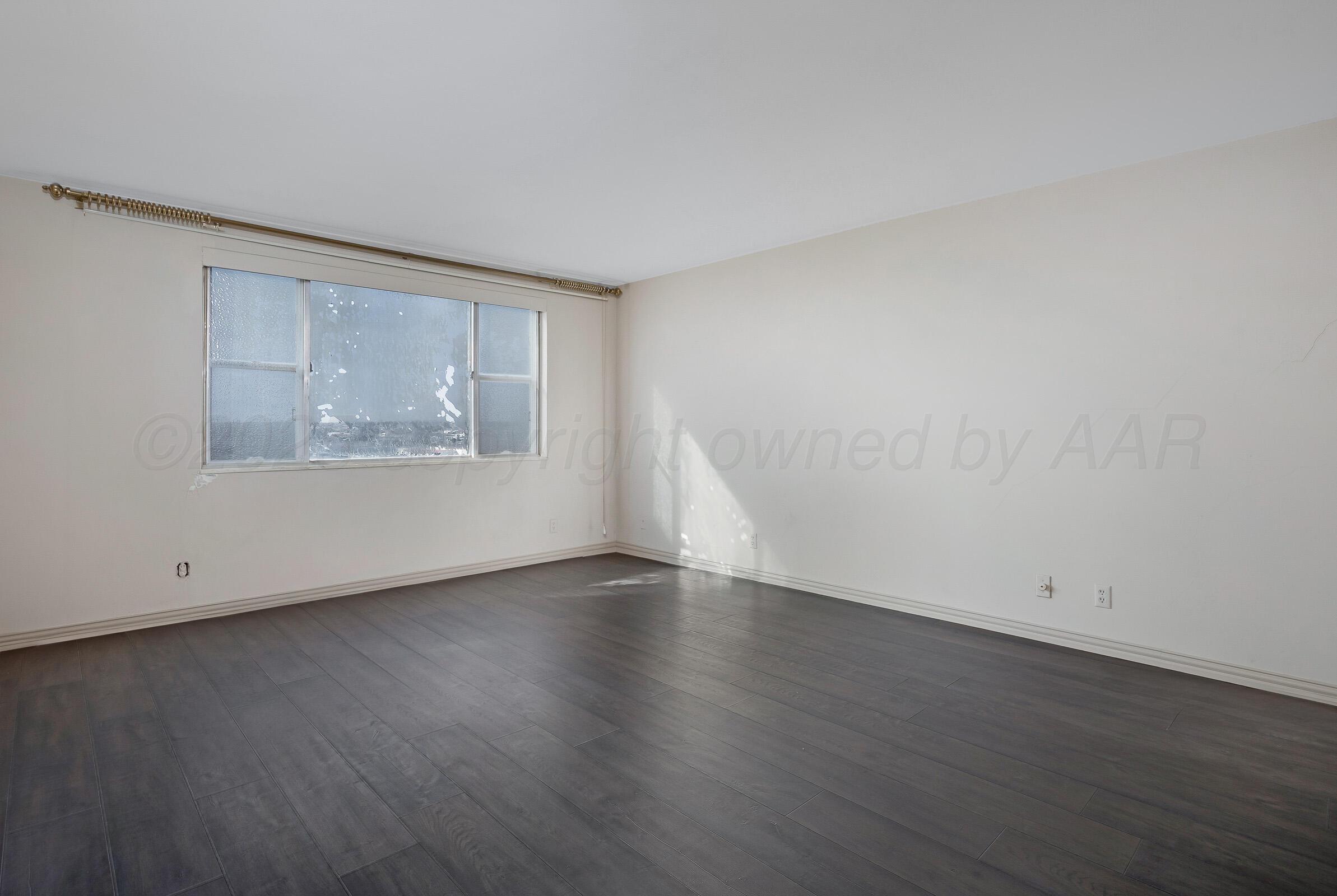 2028 South Austin Street, Unit 1104 Amarillo, TX 79109 - Photo 21 of 37 an empty room with wooden floor and windows