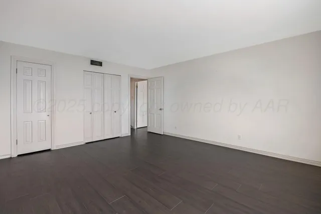 a view of an empty room and wooden floor