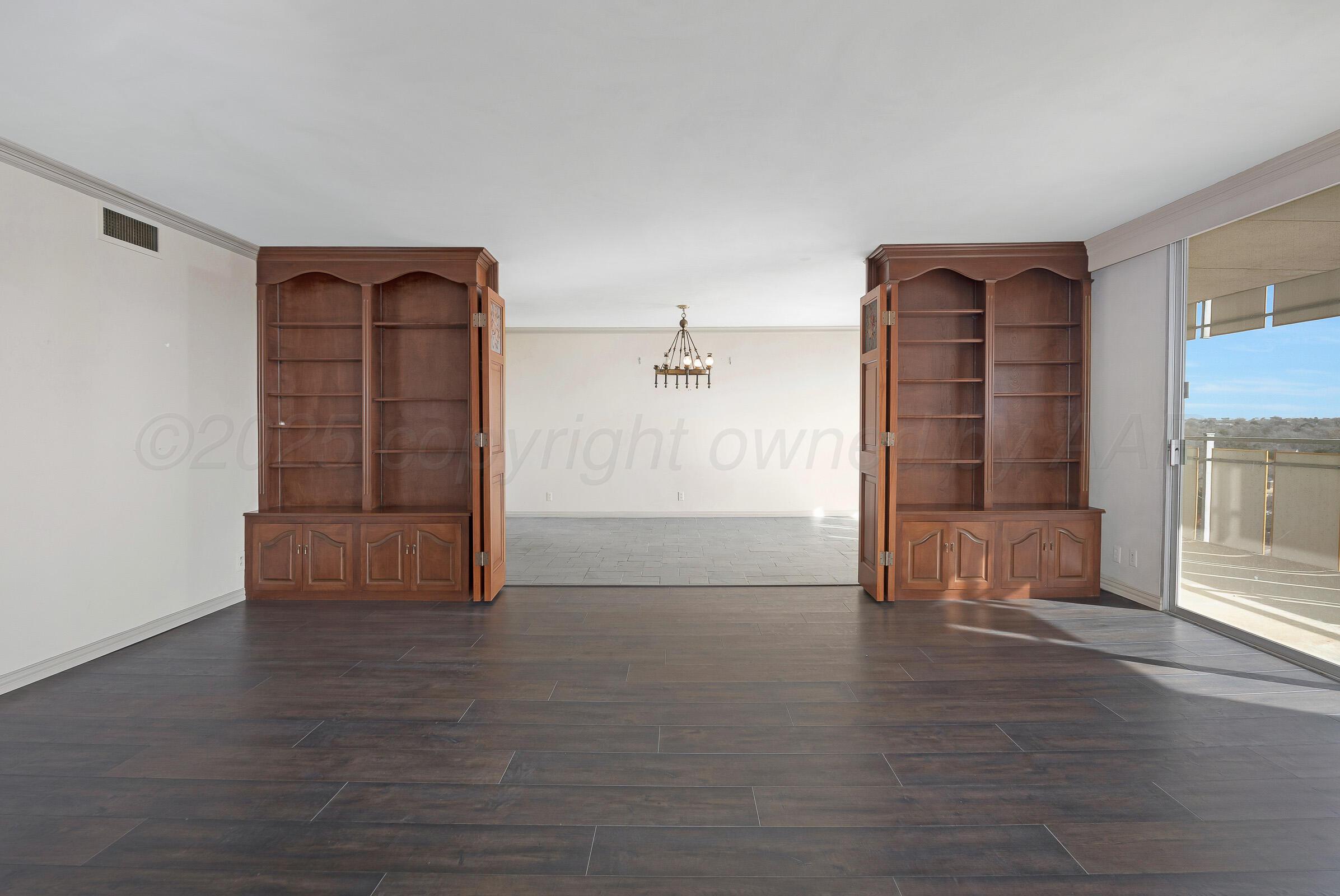 2028 South Austin Street, Unit 1104 Amarillo, TX 79109 - Photo 7 of 37 an empty room with wooden floor and windows