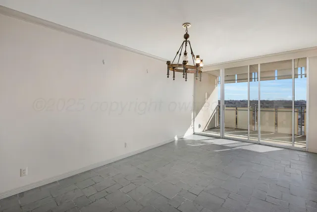a view of empty room with wooden floor and windows
