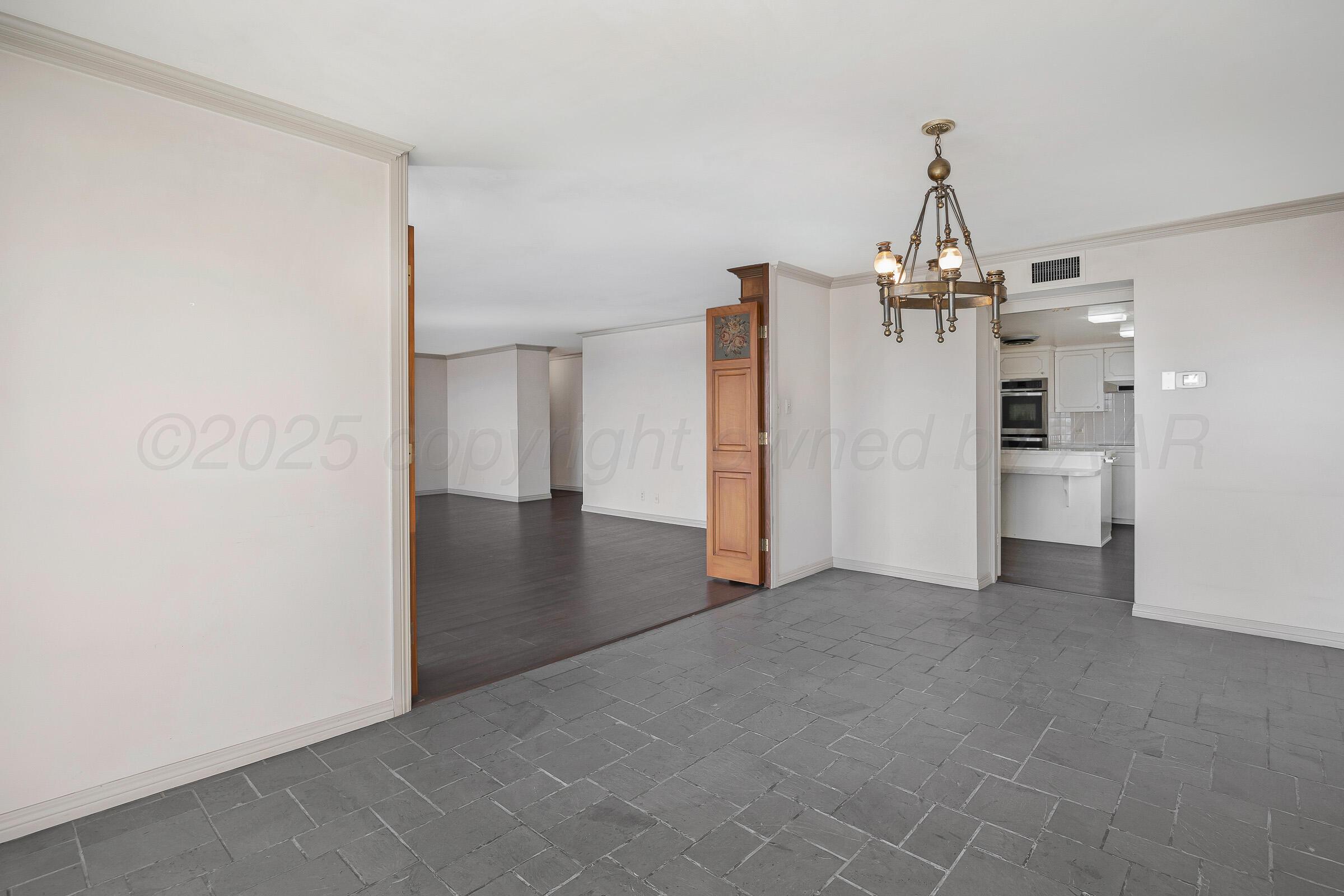 2028 South Austin Street, Unit 1104 Amarillo, TX 79109 - Photo 9 of 37 a view of a kitchen with a refrigerator and a sink