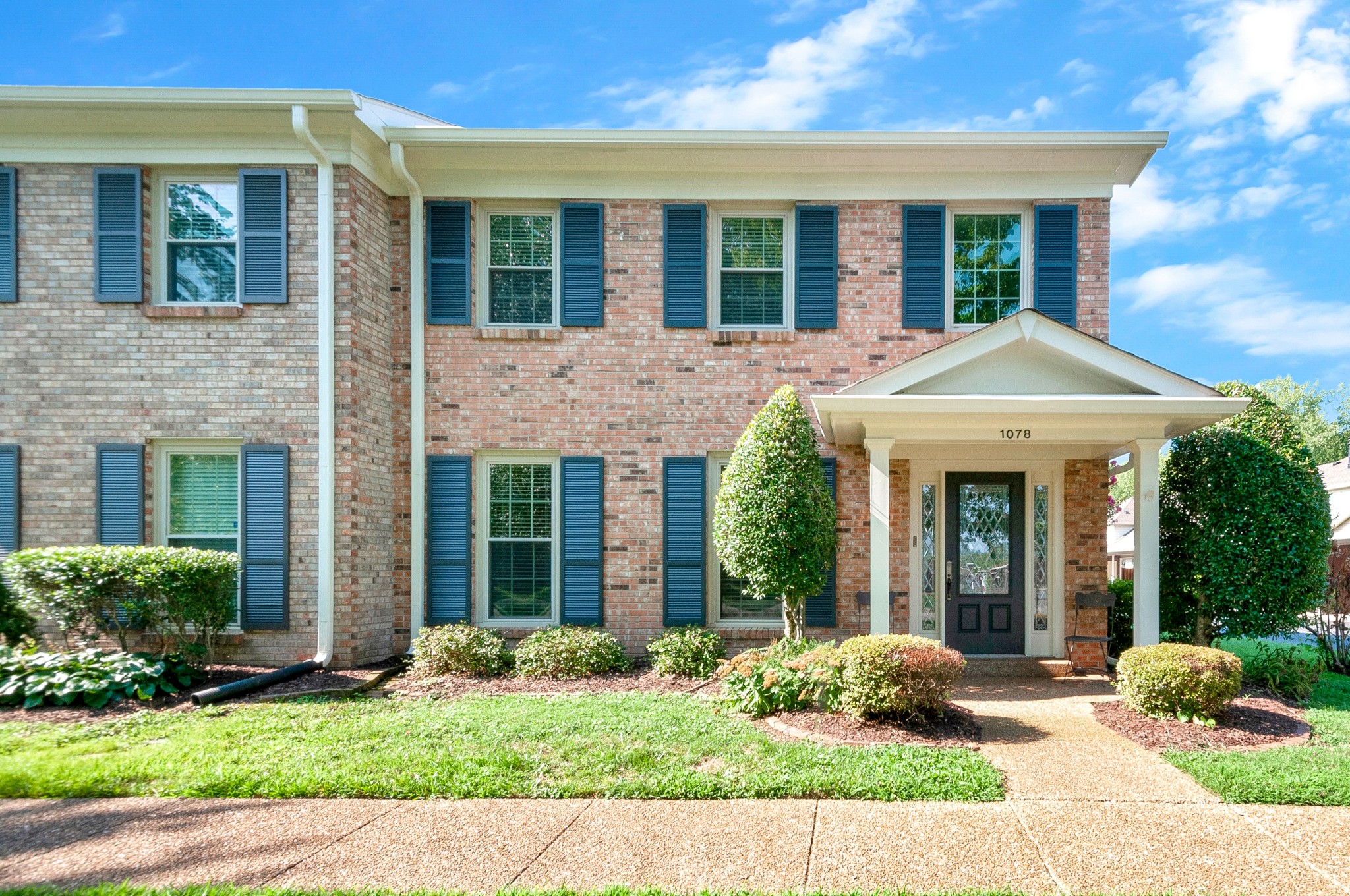 1078 General George Patton Road Nashville, TN 37221 - Photo 1 of 33 a view of a brick house with potted plants and a large window