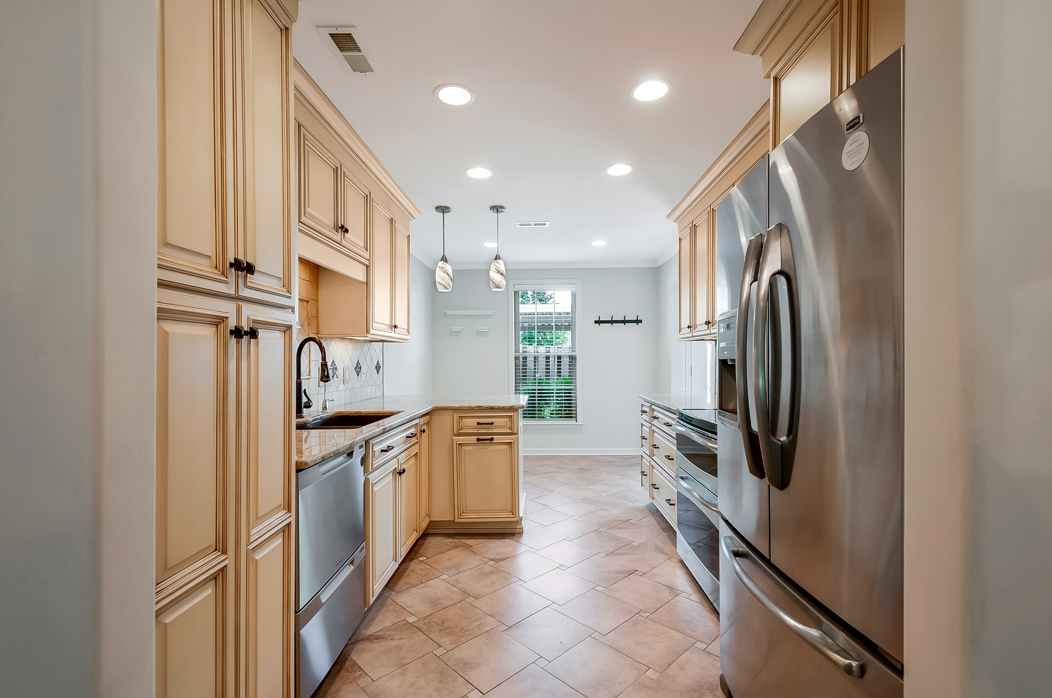 1078 General George Patton Road Nashville, TN 37221 - Photo 11 of 33 a kitchen with stainless steel appliances granite countertop a refrigerator and a sink