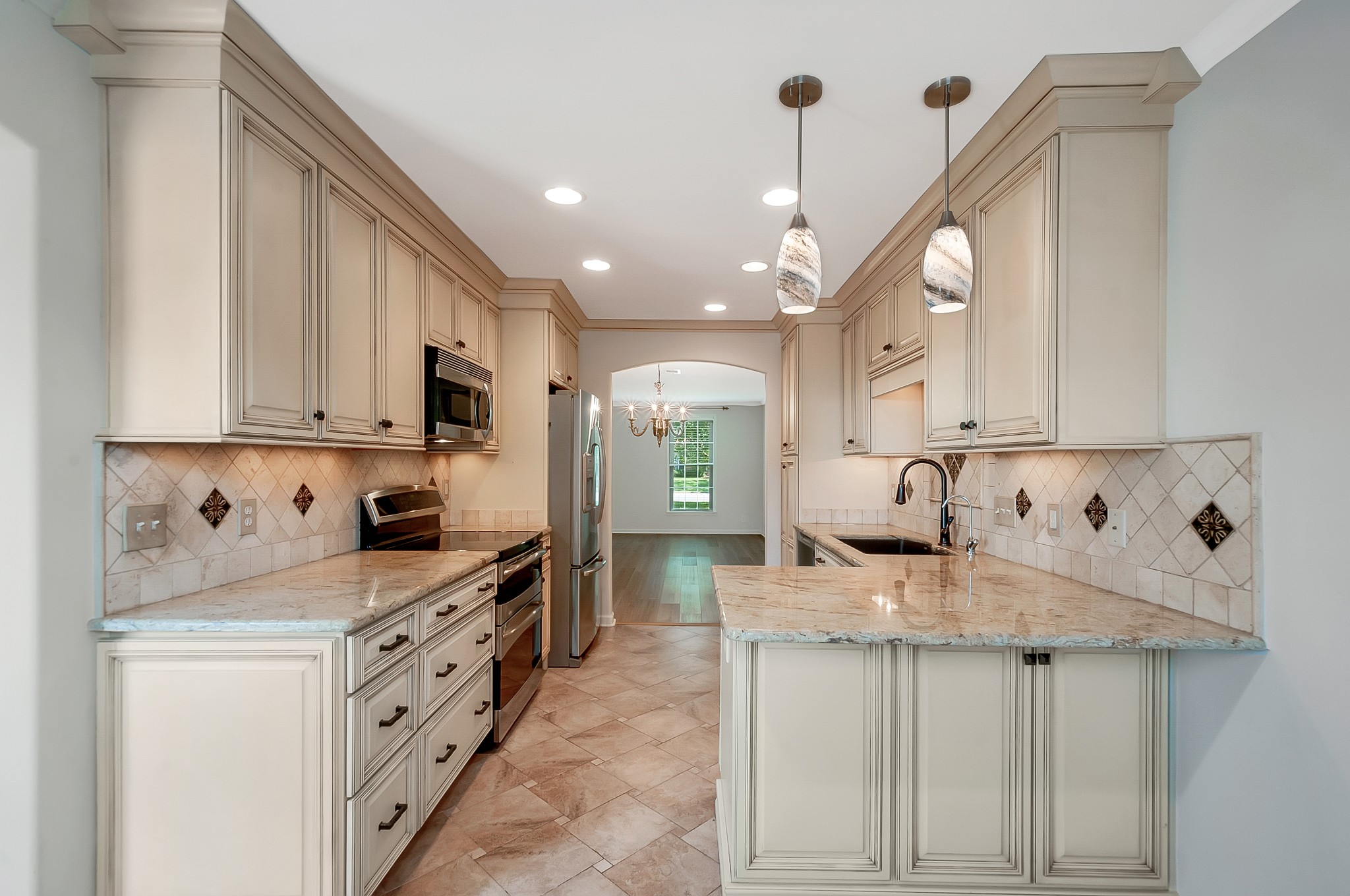 1078 General George Patton Road Nashville, TN 37221 - Photo 12 of 33 a kitchen with granite countertop a sink a stove and cabinets