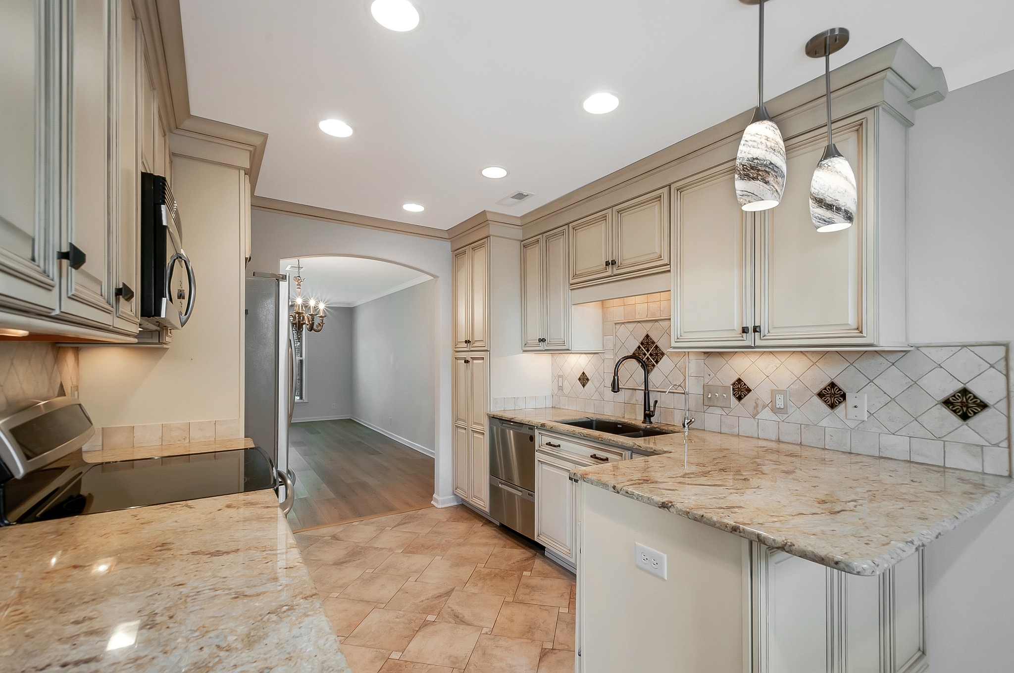 1078 General George Patton Road Nashville, TN 37221 - Photo 13 of 33 a kitchen with granite countertop a sink cabinets and stainless steel appliances