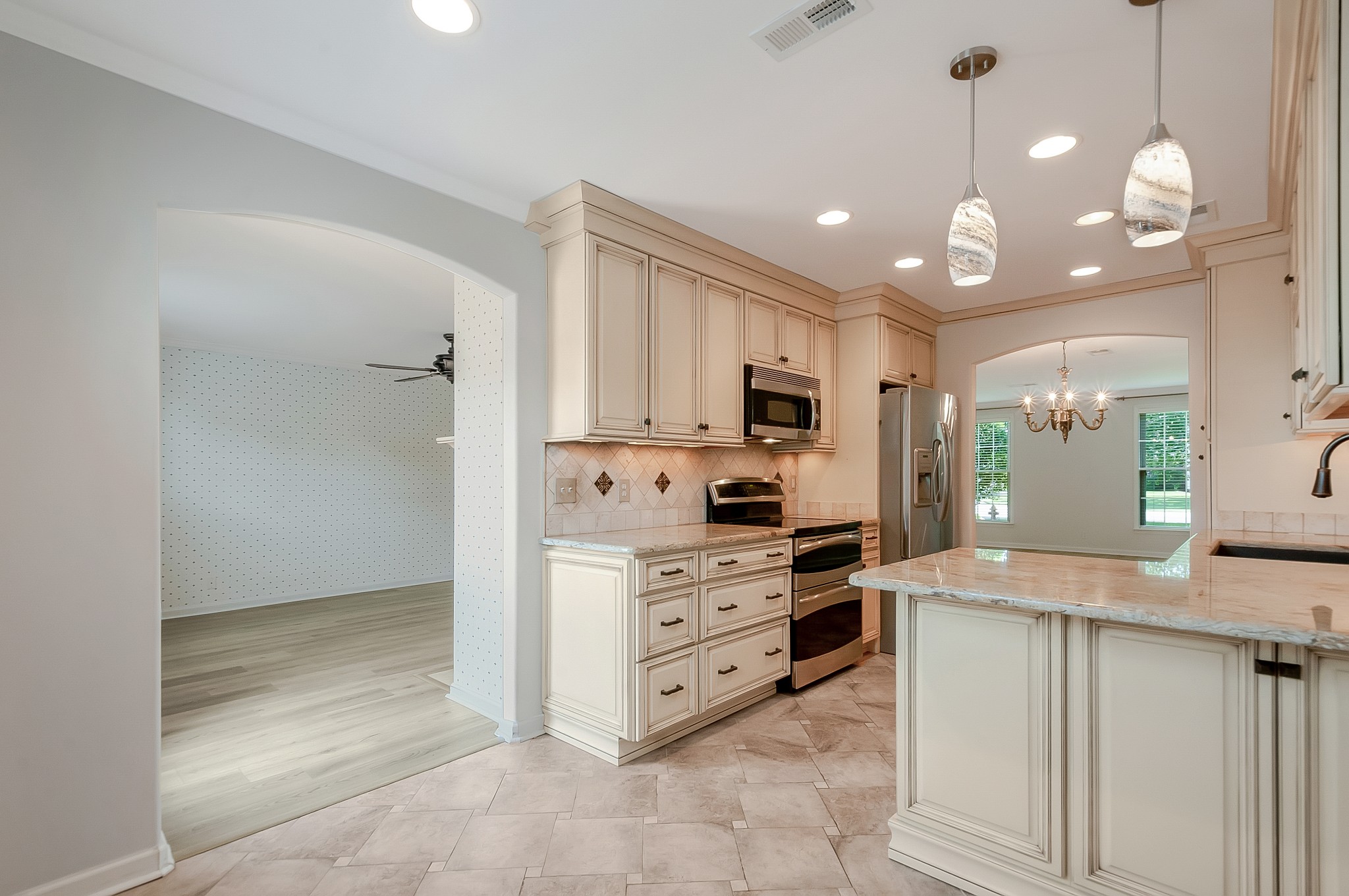 1078 General George Patton Road Nashville, TN 37221 - Photo 15 of 33 a kitchen with kitchen island granite countertop a refrigerator and a sink