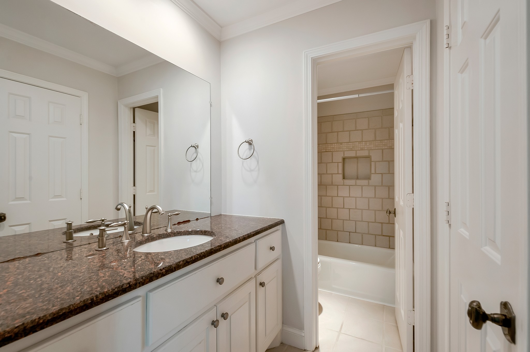 1078 General George Patton Road Nashville, TN 37221 - Photo 23 of 33 a bathroom with a granite countertop sink a mirror and a shower