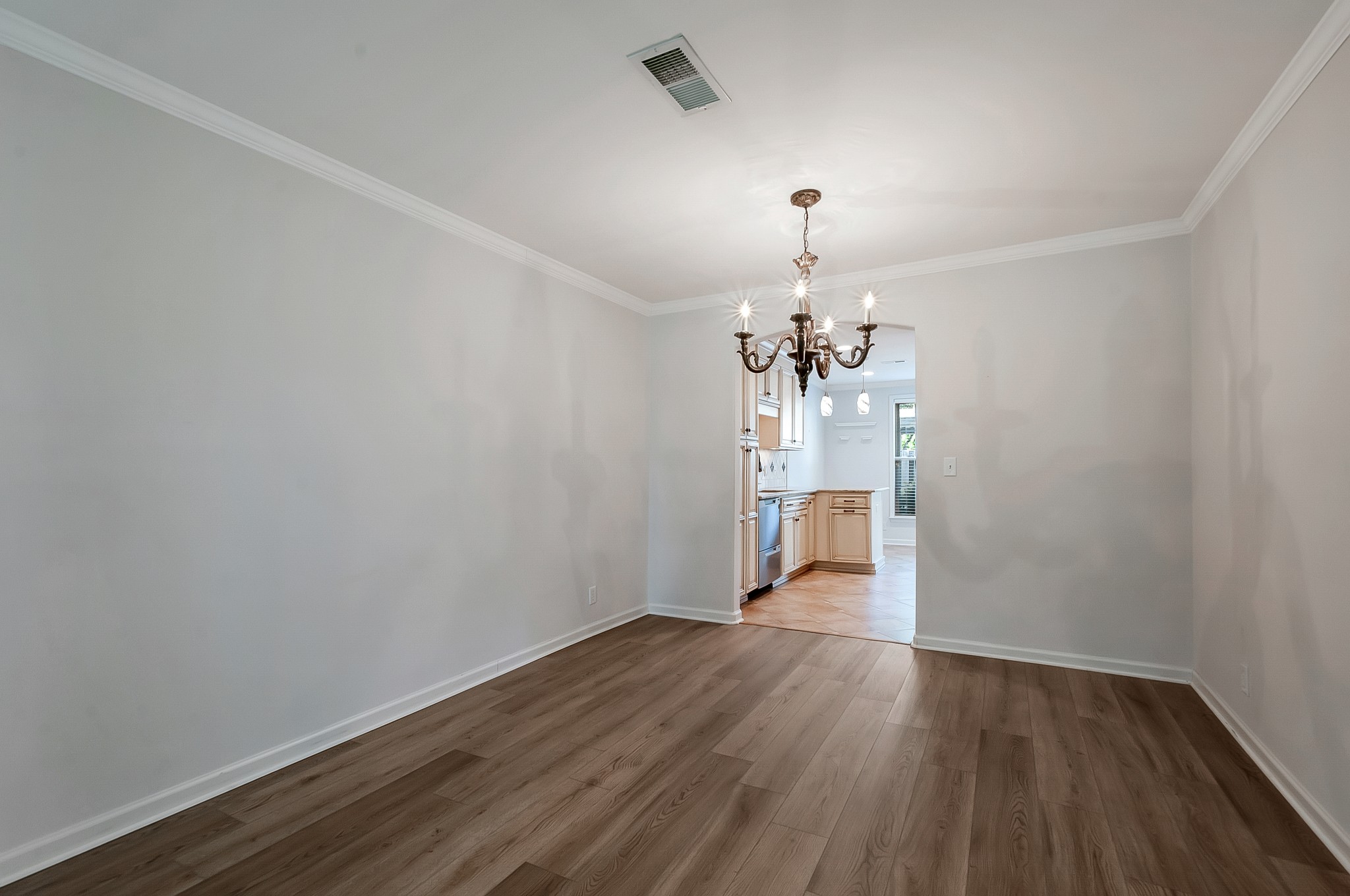 1078 General George Patton Road Nashville, TN 37221 - Photo 10 of 33 a view of a room with wooden floor and chandelier