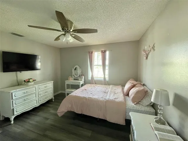 a bathroom with a granite countertop sink a toilet and a mirror