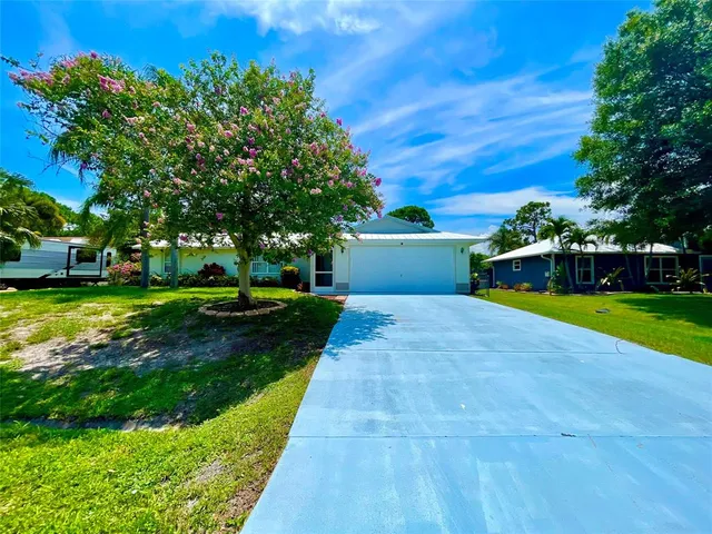 a front view of house with yard and outdoor seating