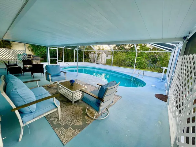 a swimming pool with outdoor seating and yard