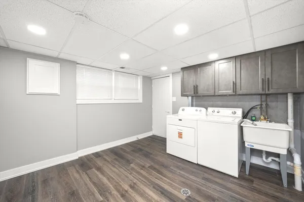 a kitchen with a sink window and cabinets