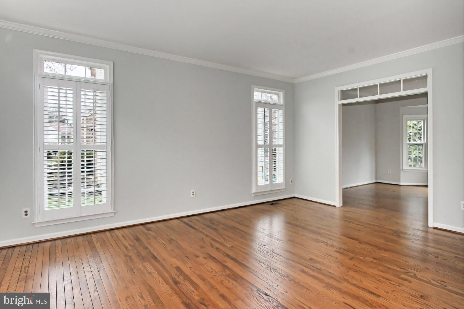 8126 Ridge Creek Way Springfield, VA 22153 - Photo 5 of 50 a view of an empty room with wooden floor and a window