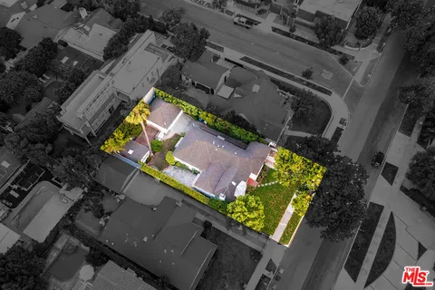 an aerial view of house with a yard