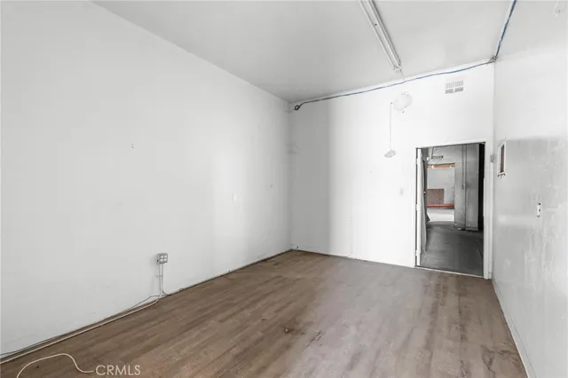 a view of hallway with wooden floor