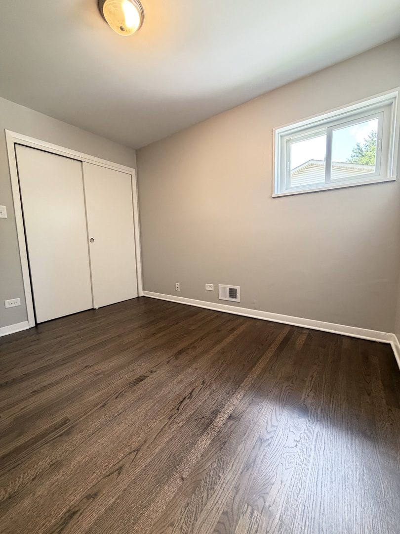 1820 169th Street Hazel Crest, IL 60429 - Photo 17 of 23 an empty room with wooden floor and windows