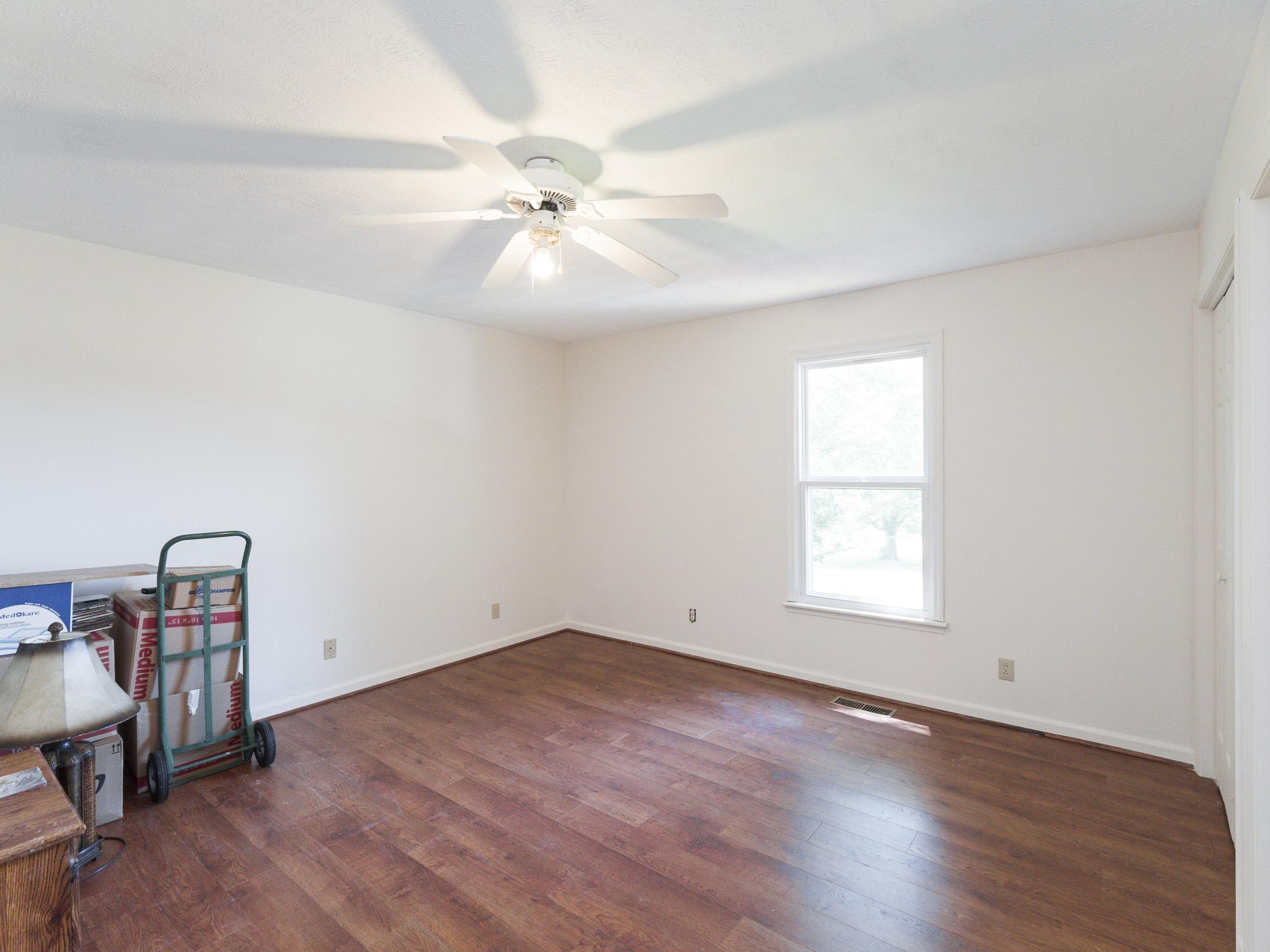 3609 Raymond Head Road Springfield, TN 37172 - Photo 18 of 30 an empty room with wooden floor fan and windows
