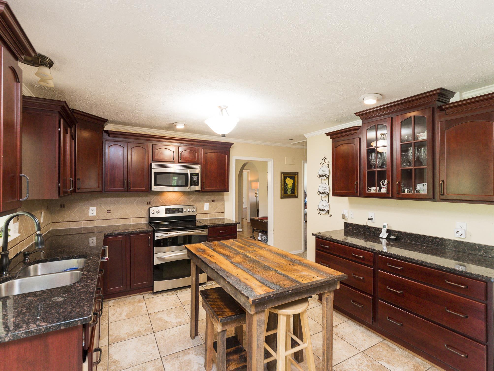 3609 Raymond Head Road Springfield, TN 37172 - Photo 9 of 30 a kitchen with stainless steel appliances granite countertop a sink stove and refrigerator
